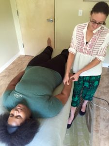 Jamee Williams, LMT, demonstrates Acupressure on her colleague.