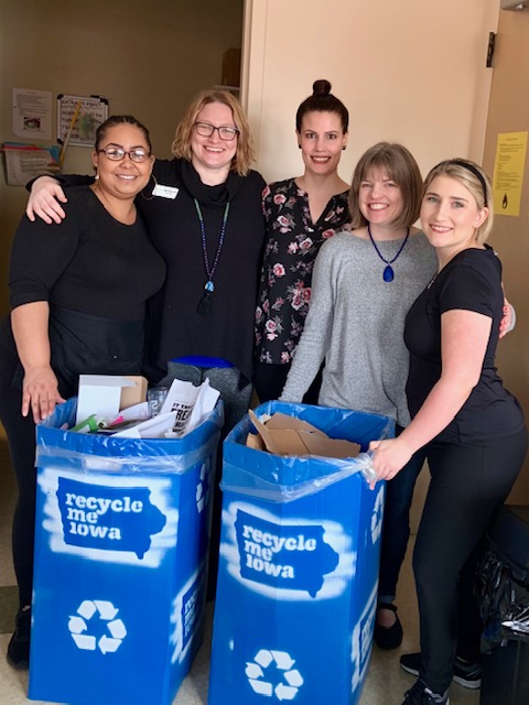 East Village Spa employees with recycle me Iowa storage containers